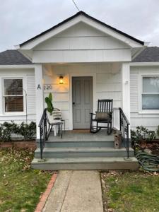 a house with a porch with a bench on it at C Street Cottages in Jacksonville