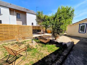 a group of chairs and a table in a yard at L'Antre du Pin in Lourdes +7 photos