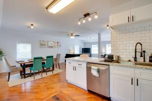 a kitchen with white cabinets and a table with green chairs at Peaceful Country Apt Extended Stays Welcome! in Pataskala