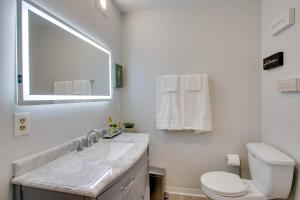 a white bathroom with a sink and a toilet at Peaceful Country Apt Extended Stays Welcome! in Pataskala +17 photos