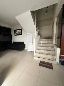 a living room with a staircase and a couch at Hospedaje Paraíso in Trujillo