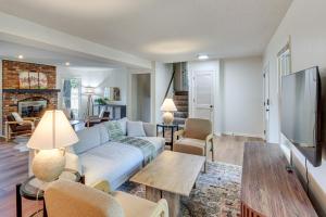 a living room with a couch and a tv at 19 Mi to Kansas City Group Retreat with Game Room! in Blue Springs