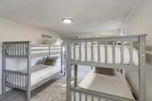 two bunk beds in a small room with at 19 Mi to Kansas City Group Retreat with Game Room! in Blue Springs