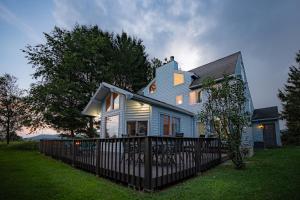 a blue house with a fence in front of it at Panorama Point - Sauna, hot tub, theater room in Davis