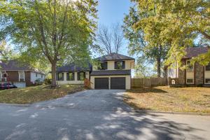 a house with a driveway in front of a house at 19 Mi to Kansas City Group Retreat with Game Room! in Blue Springs
