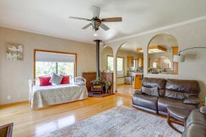 a living room with a bed and a couch at 3 Mi to Sequoia Park Zoo Spacious Home with Sunroom in Rosewood