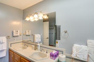 a bathroom with a sink and a large mirror at 3 Mi to Sequoia Park Zoo Spacious Home with Sunroom in Rosewood +30 photos
