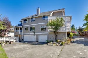 a large white house with a garage at 3 Mi to Sequoia Park Zoo Spacious Home with Sunroom in Rosewood