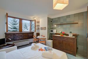 a room with a kitchen and a bed in a room at Fiori di Miele - Happy Rentals in Bardonecchia +11 photos