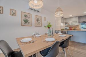 a wooden table with chairs and a dining room at Vipava River Retreat - Happy Rentals in Vipava