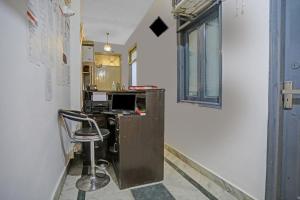 an office with a desk with a computer and a chair at Hotel O The Premium Villa in New Delhi