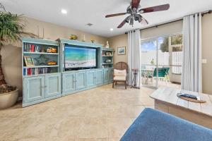 a living room with a tv and a ceiling fan at Summerlake 29 in Destin