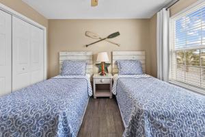 a bedroom with two beds and a window at Summerlake 29 in Destin +15 photos
