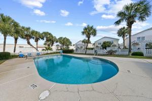 a swimming pool in a driveway with palm trees at Summerlake 29 in Destin