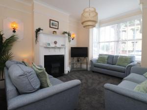 a living room with two couches and a fireplace at Seaside Villa in Bridlington