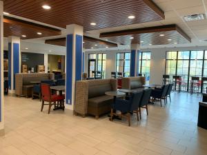 a restaurant with tables and chairs in a building at Holiday Inn Express Durango Downtown- Animas River in Durango