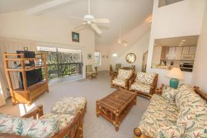 a large living room with couches and a tv at 6BR Poipu Kai Oceanfront Retreat Steps to 3 Beaches in Koloa