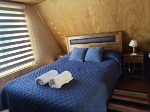 a bedroom with a bed with two towels on it at Valentine's Day Host Mary Leo Accommodation House in Cochrane
