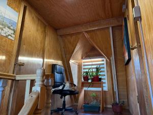 a small room with a chair and a window at Valentine's Day Host Mary Leo Accommodation House in Cochrane