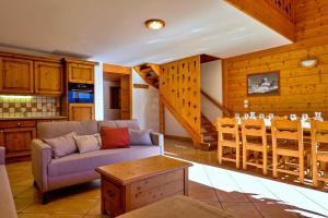 a living room with a couch and a table at Rochu 10 personnes Spa, Calme & Vue Montagne in Champagny-en-Vanoise