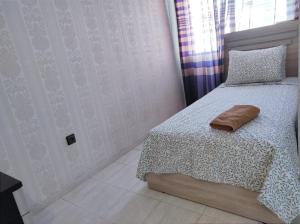 a bedroom with a bed with a pillow and a window at heartofrabat in Rabat