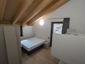 a small room with a bed and a window at Chalet Serenella in Valdidentro