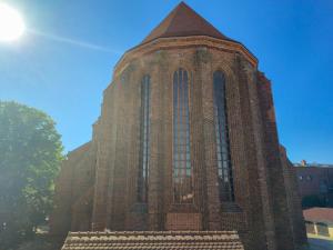 a tall brick building with a tall tower at Haus Marienblick in Beeskow