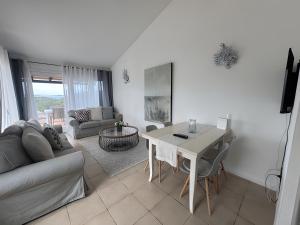 a living room with a table and a couch at Appartamento Sea View in Arzachena