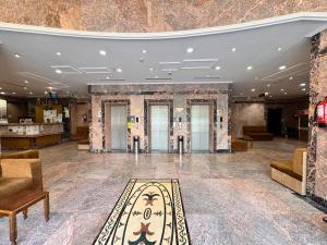 a lobby with a rug in the middle of a room at Cent Al Khair Hotel Makkah in Makkah