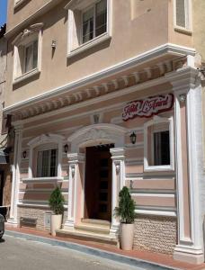 a building with two potted plants in front of it at Amirale in Oran