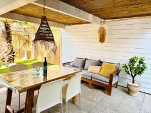 a patio with a wooden table and a couch at Casa Guilia in La Ciaccia
