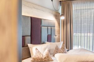 a bedroom with a bed with white pillows at Hotel zum Schwanen - Appartement 2 in Pflach