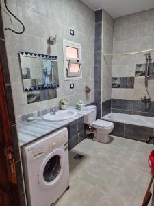 a bathroom with a washer and a washing machine at Star Apartment Hurghada in Hurghada