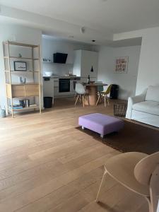 a living room with a couch and a table at Feigental in Überlingen +5 photos