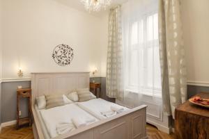 Masná 19 - Old Town Residence في براغ: سرير في غرفة مع نافذة كبيرة