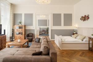 a living room with a couch and a bed at Masná - Old Town Residence in Prague