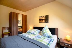 a bedroom with a bed with two pillows on it at Fewo 1 in Friedrichswalde