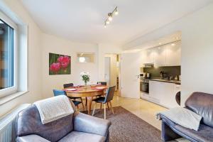 a living room with a table and chairs and a kitchen at Ferienwohnung Schwarzwaldperle in Baden-Baden