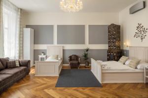 a living room with a couch and a chair at Masná - Old Town Residence in Prague +28 photos