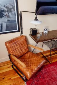 a brown chair in a room with a table at Dofflemyer Hotel in San Saba +27 photos