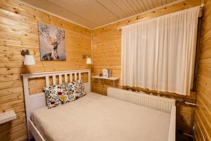 a bedroom with a bed in a wooden cabin at Zegzug Noszvaj in Noszvaj