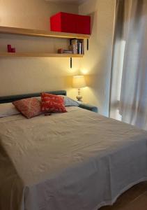 a bed with two pillows on it in a bedroom at Ninette, intimità e natura in Sauze di Cesana