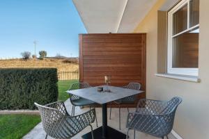 a table and chairs sitting on a patio at Landhaus Antonius Eppan in Appiano sulla Strada del Vino