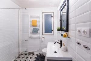 a white bathroom with a sink and a shower at Zegzug Noszvaj in Noszvaj +14 photos
