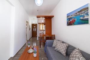 a living room with a couch and a table at Villa Virginia in Andros