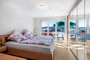 a bedroom with a bed and a balcony at Ferienwohnung Hochtal in Bernau im Schwarzwald