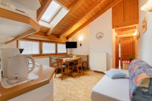 a small room with a bed and a dining room at Friedheim Appartments in Sarntal