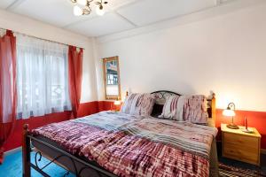 シルタッハにあるFerienwohnung im Strumpfweberhausのベッドルーム1室(赤い壁のベッド1台、窓付)