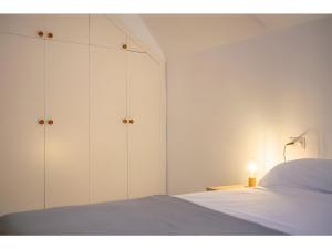 ein Schlafzimmer mit weißen Schränken und einem weißen Bett in der Unterkunft El Lledoner in Sant Jaume de Llierca + 24 Fotos