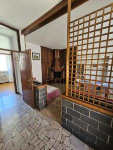 a bedroom with a bed and a desk in a room at Riverside San Pellegrino in San Pellegrino Terme